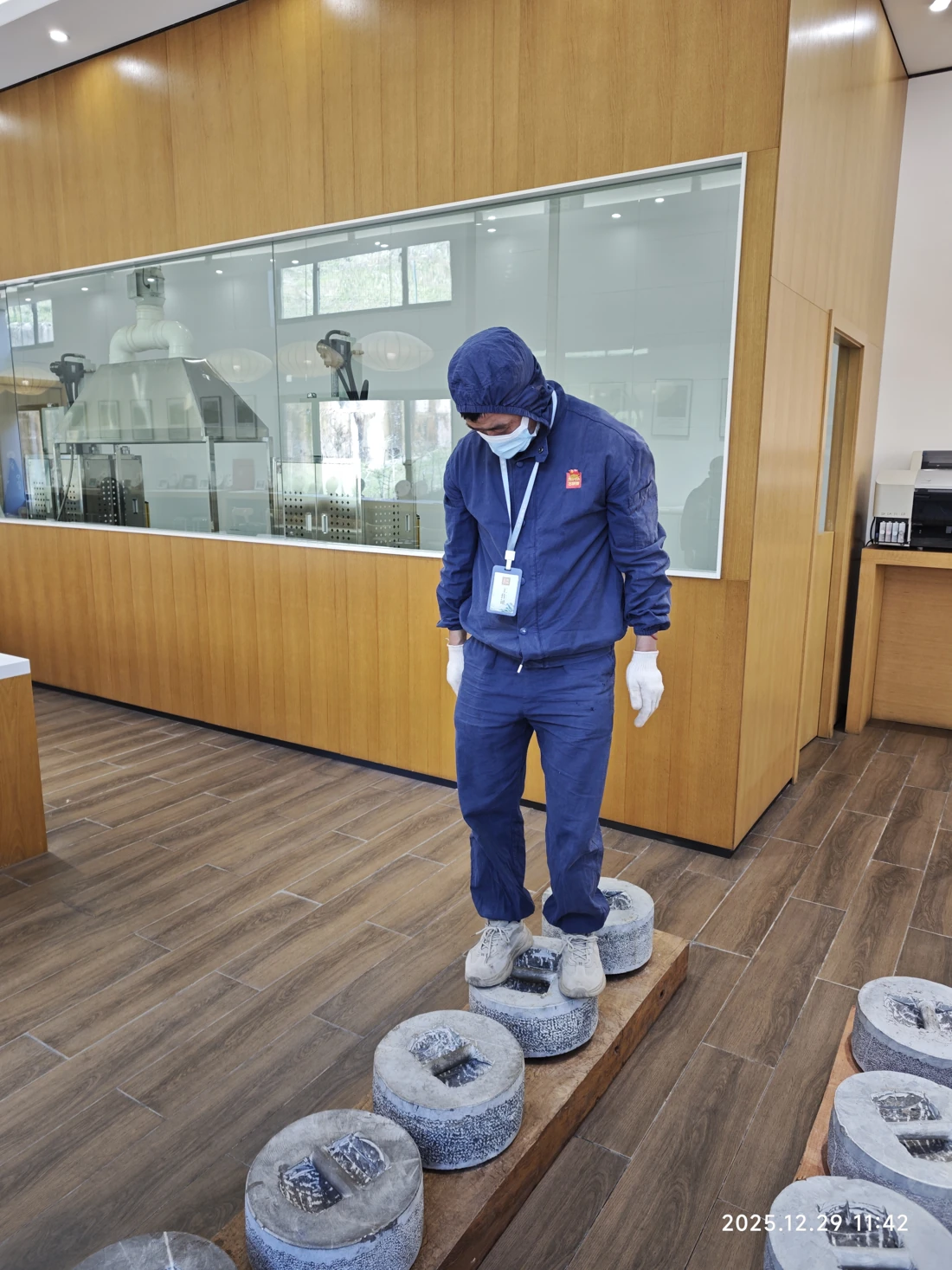 During the demonstration, an adult stood on the stone press to add weight and increase the pressing force.