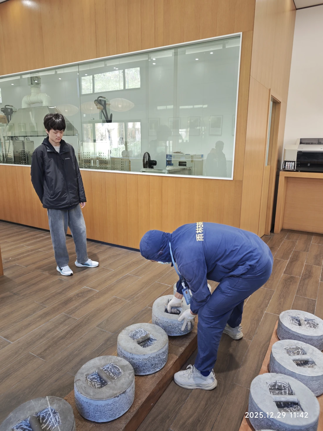 Pressing with a stone weight.